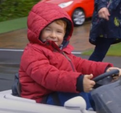 photo of a boy in a toy car